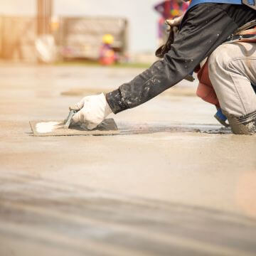 Construction worker working on concrete foundation